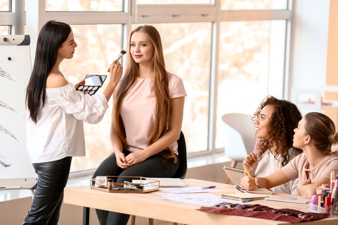 Young Woman Teaching Students in Makeup School